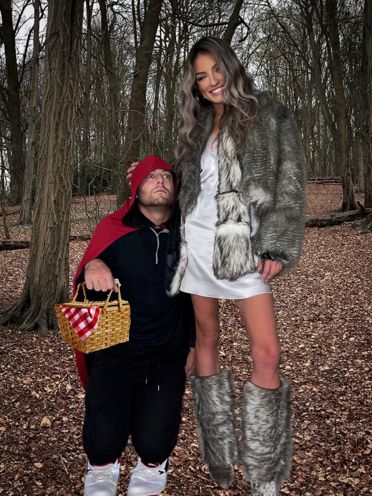 a man and woman dressed up in costumes posing for a photo with trees behind them