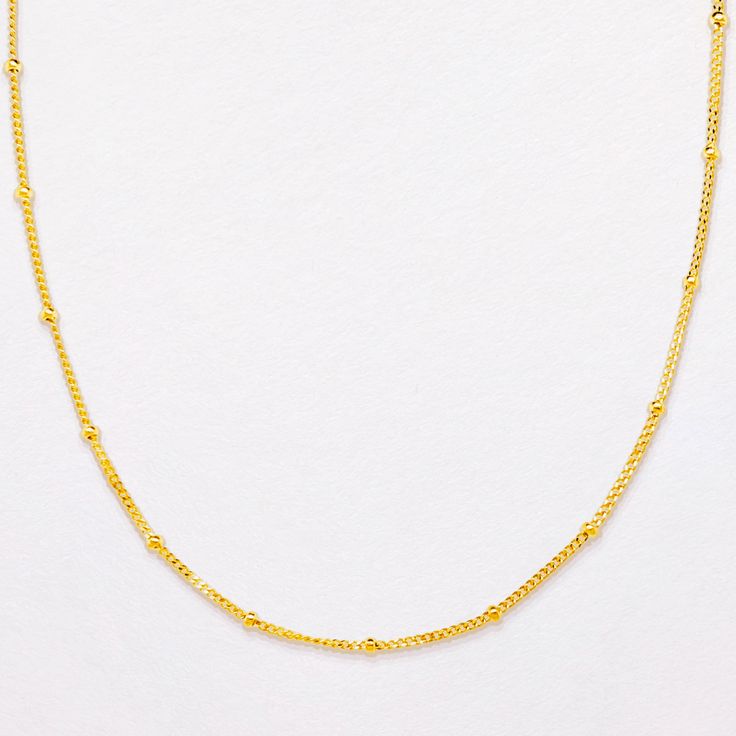 A delicate statement all on its own, the Satellite Chain Necklace features solid gold orbs accented along a dainty diamond cut curb chain for extra sparkle. This is everyday luxury at its finest. The 16.5" length sits right on the décolletage, to match any neckline and adds texture to a layered stack. Looking for more images? View this style in white gold. This piece is part of our Complements Collection, to see all styles click here. Details: 9k Solid Gold diamond cut curb and ball chain Solid Classic Gold Plated Satellite Chain Necklace, Classic Satellite Chain Necklace For Formal Occasions, Dainty Formal Satellite Chain Necklace, Dainty Satellite Chain Necklace For Formal Occasions, Dainty Satellite Chain Necklace For Formal Events, Chain Threader Earrings, Everyday Luxury, Solid Gold Chains, Sparkling Diamond