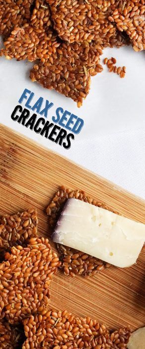 a wooden cutting board topped with flax seed crackers