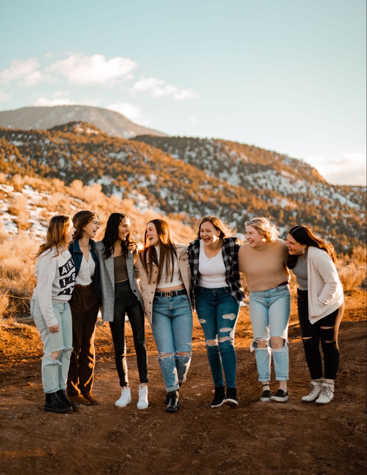 four girls are standing together in the desert