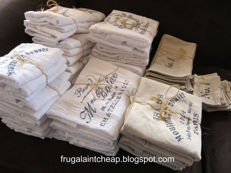 a pile of white towels sitting on top of a couch