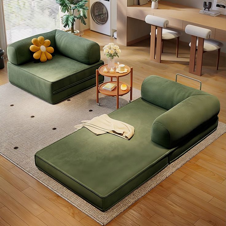 a living room with two green couches and a coffee table in the center area