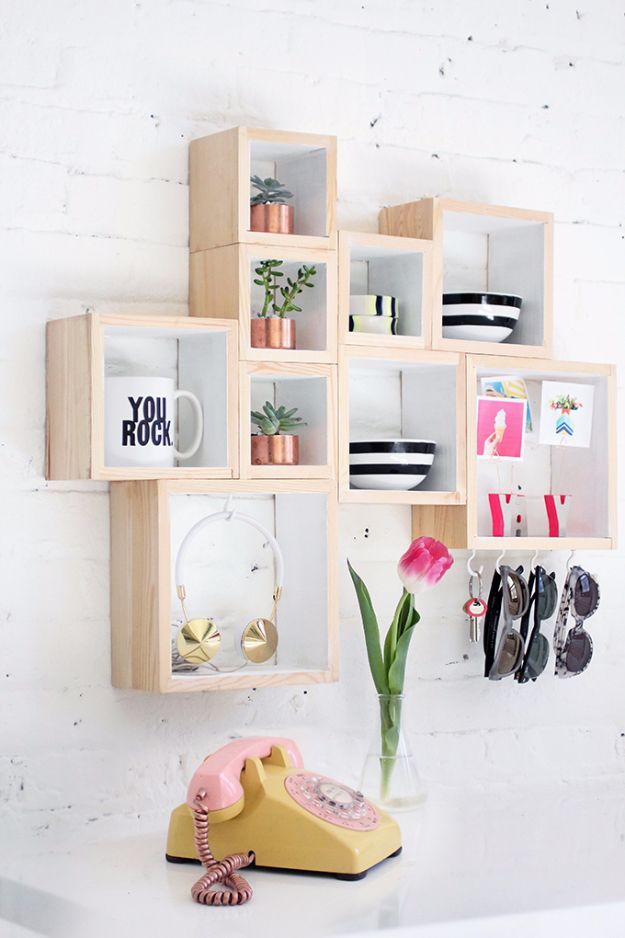 a phone is sitting on a shelf next to a vase with tulips in it