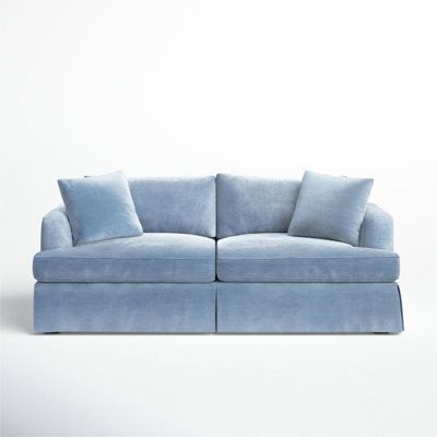 a blue couch with two pillows on it