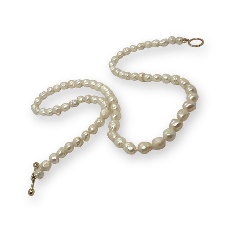 Lustrous 5mm sustainably grown, white pearls on a white silk, hand-tied line. This 14” length choker exudes timeless elegance, while still being on trend. The 14k gold toggle adds a touch of luxury, creating a sophisticated piece that can be stylishly layered with other necklaces and chains for a trendy and versatile look. Adjustable Pearl Chain Necklace For Formal Occasions, Classic Adjustable Pearl Necklace For Formal Occasions, Classic Adjustable Necklace With Pearl Charm, Classic Adjustable Pearl Charm Necklace, Classic Pearl Lariat Necklace, Formal Adjustable Pearl Necklace With Pendant, Elegant Adjustable Pearl Necklace With Sterling Silver Clasp, Classic Adjustable Pearl Necklace With Pearl Chain, Classic Single Strand Pearl Necklace For Everyday