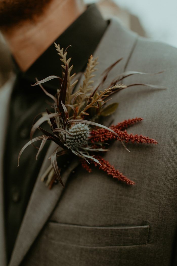 a man in a suit with a boutonniere on his lapel