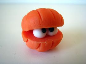 an orange toy with googly eyes sitting on a table