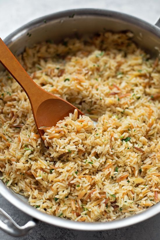 a wooden spoon in a pot filled with rice