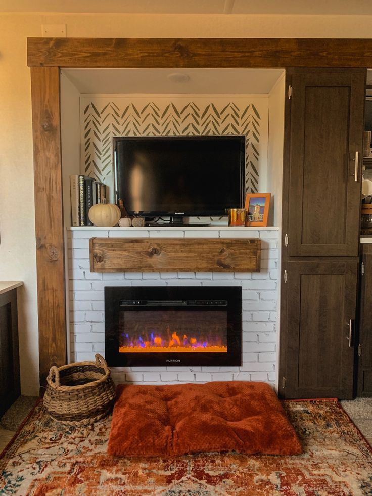 a living room with a fireplace and entertainment center