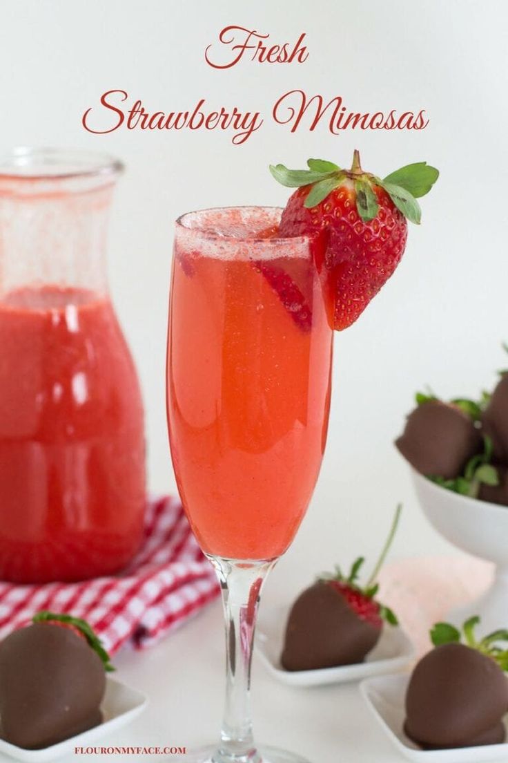 a strawberry drink in a glass next to chocolate covered strawberries