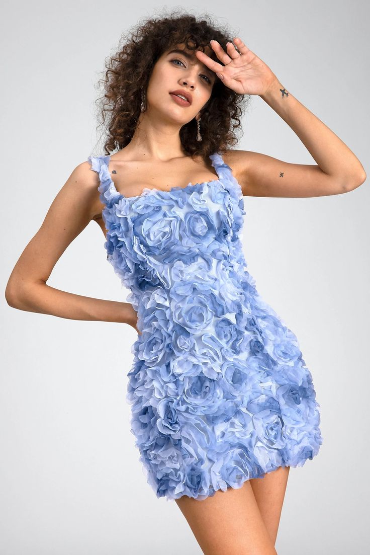 A whimsical masterpiece that captures the essence of romance and charm. Crafted with meticulous attention to detail, this dress is adorned with intricate 3D floral embellishments that cascade delicately across the fabric. The vibrant blue hue adds a touch of boldness and sophistication, making this dress perfect for any special occasion. The mini length exudes youthful flair, while the figure-flattering silhouette ensures a stunning look that turns heads wherever you go. Whether you're attending a garden party, a summer soirée, or a romantic date night, the 3D Floral Mini Dress promises to make a statement. Pair it with your favorite heels and accessories to complete the look, and embrace your inner elegance with this enchanting ensemble. Handmade customization Fabric composition: 90% poly Blue Floral Applique Dress For Prom, Blue Floral Applique Prom Dress, Chic Floral Embroidered Dresses For Prom, Elegant Light Blue Dress With Floral Applique, Blue Floral Applique Wedding Dress, Chic Prom Dresses With Floral Embroidery, Blue Wedding Dress With Floral Applique, Blue Fitted Dress With Floral Applique, Fitted Blue Dress With Floral Applique