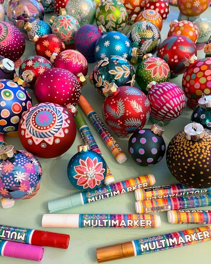 many different colored markers and ornaments on a table