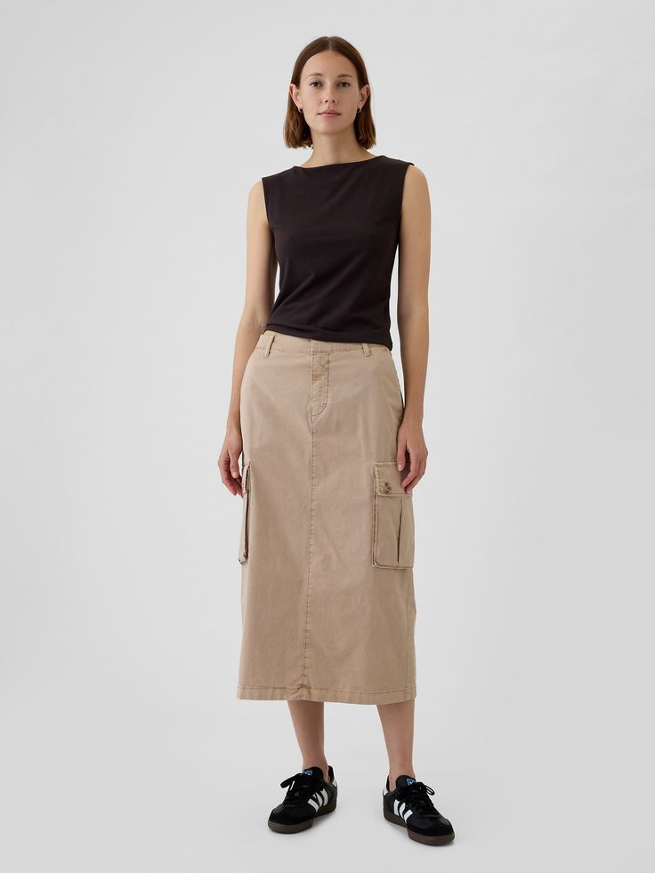 Soft, stretch utility midi skirt.  Button closure, zip fly.  Front slant pockets, back welt pockets.  Side cargo pockets.  Slit at back hem.  * Fit: Classic.  A pencil silhouette that's slim at the waist & easy through the hip with a tapered opening.  Hits below the knee.  Models wearing Gap Long Khaki Skirt Outfit, Cargo Midi Skirt Outfit, Khaki Skirt Outfits, Long Khaki Skirt, Midi Cargo Skirt, Utility Fashion, Cargo Skirt Outfit, Queer Style, Cargo Midi Skirt