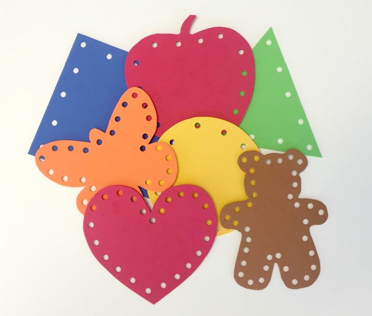 paper cutouts with hearts, teddy bears and an apple on them are arranged next to each other