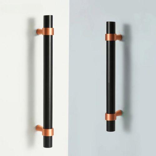 two black and copper handles on the wall