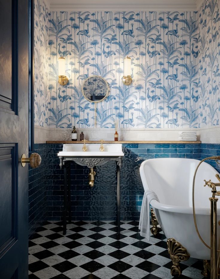 a bathroom with blue and white tiles on the walls, two sinks and a bathtub