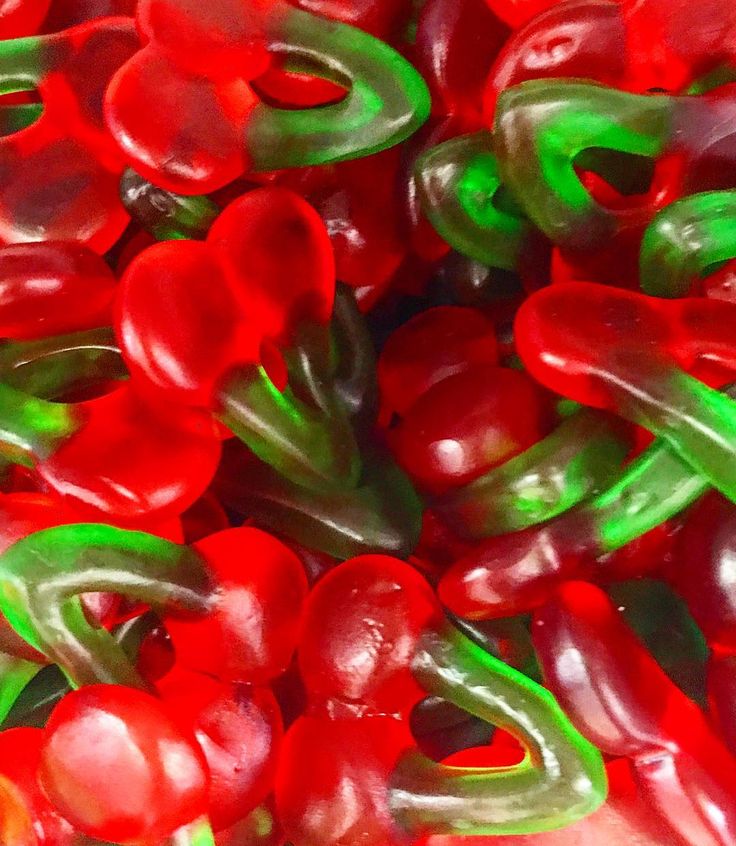 red and green gummy bears in a pile