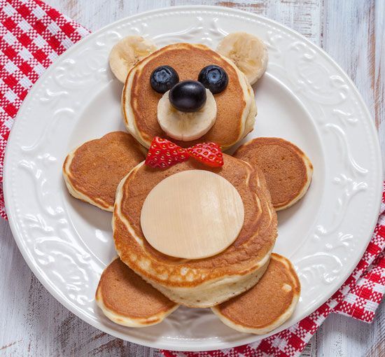 a teddy bear made out of pancakes on a plate