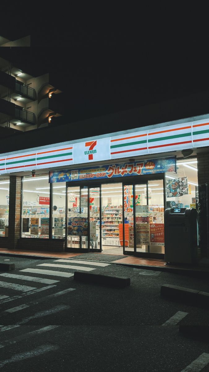 an empty store front at night with the lights on