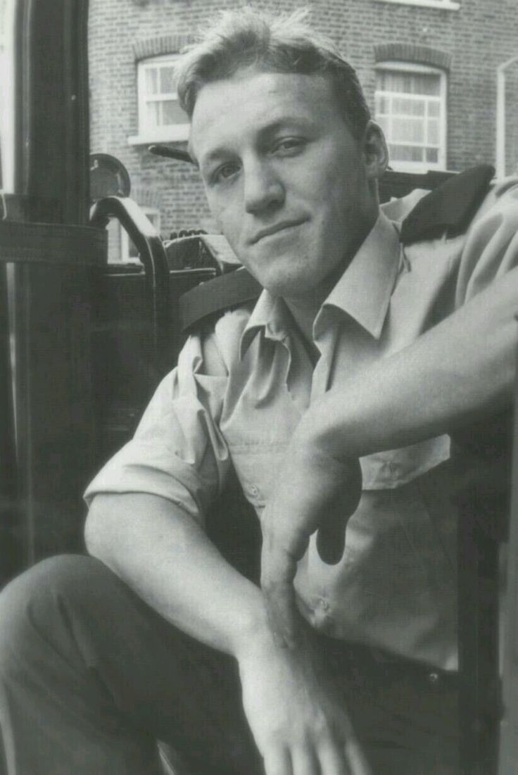 a black and white photo of a man sitting in a chair