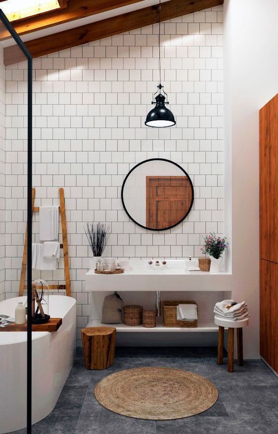 a bathroom with white tile and wooden accents