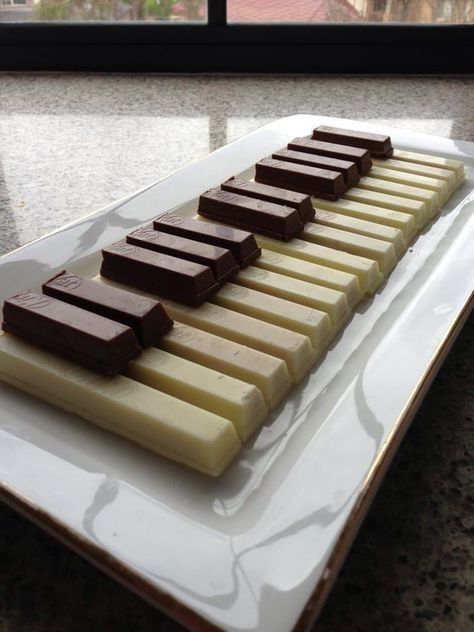 a white plate topped with chocolate and marshmallows on top of a counter