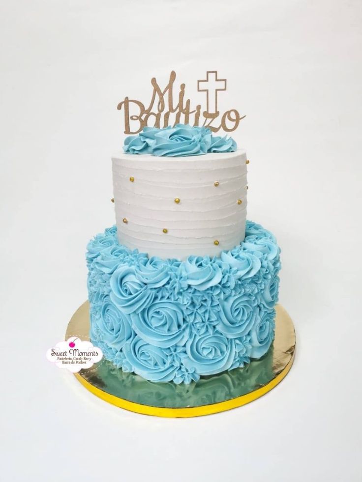 a three tiered cake with blue frosting and gold sprinkles on top