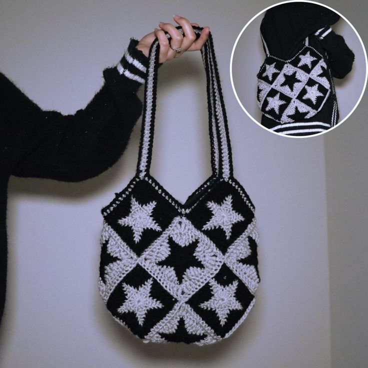 a woman is holding a black and white purse with an attached strap that has stars on it