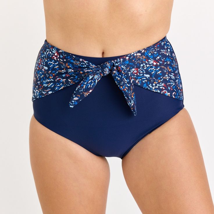 Step up your beach style with our High-Waisted Bikini Bottom featuring a chic front tie detail. Sized to perfection, the hem circumference is 62 cm and the thigh circumference is 49 cm for a Size S. When in doubt, it's best to size up for a comfortable fit. Crafted from 82% nylon and 18% spandex, this fully-lined bikini bottom offers UPF 50+ sun protection and quick-drying capabilities. Sold as a bottom only, you have the freedom to mix and match with your favorite tops. Keep it fresh and vibran Adjustable Beachwear Tankini With Tie-side Bottom, Beachy Tankini With Tie-side Bottom For Swimming, Navy Tankini For Pool Beachwear, Navy Beachwear Tankini For Pool, Beachwear High-waist Swimwear For Beach, High Waist Beachwear For Beach, Summer Navy Triangle Top Swimwear, Navy Triangle Top Swimwear For Summer, Blue Tie-side Swim Skirt