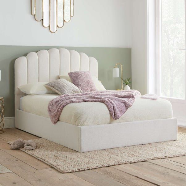 a white bed sitting on top of a wooden floor