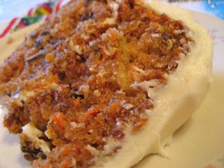 a piece of carrot cake sitting on top of a white plate