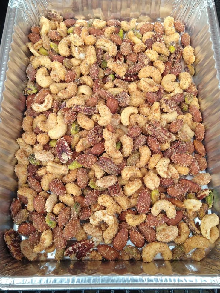 nuts in a plastic container sitting on top of a stove