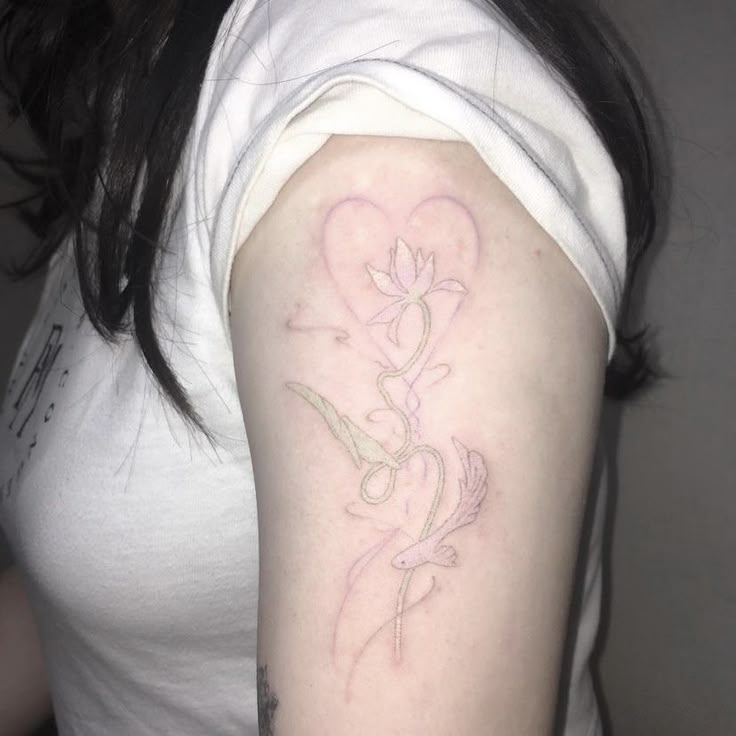 a woman's arm with a flower tattoo on the left side of her arm