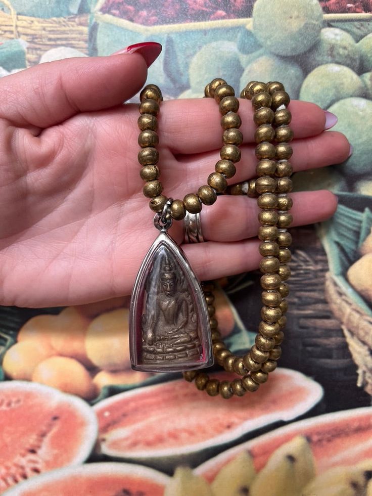 This stunning seated meditating Buddha is vintage and full of amazing detail. This vintage amulet is encased in a new plastic and silver pendant and attach to midsize recycled metal beads from Ghana. A statement necklace filled with blessings that can be worn and add a specialist any outfit. Found at a vintage market outside of Bangkok, Thailand. 32" chain with 2" amulet. Meditating Buddha, Astrology Jewelry, Buddha Meditation, Crystal Shoes, Vintage Market, Recycled Metal, Bangkok Thailand, Metal Beads, Ghana