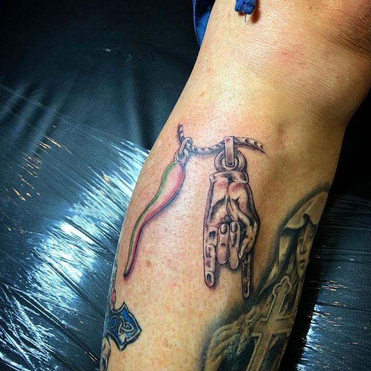 a tattoo on the leg of a person with scissors in their hand and an arrow coming out of it