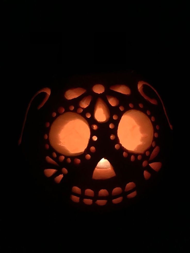 a pumpkin carved to look like a face with circles on it's side and eyes