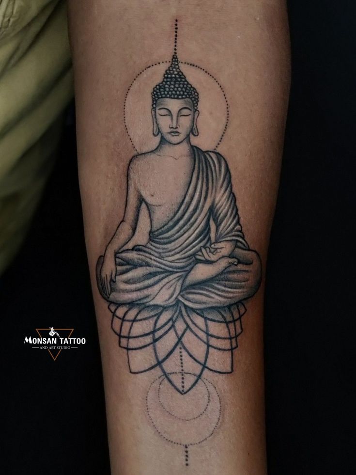 a buddha tattoo on the arm and leg is shown in black and grey ink, with an intricate design