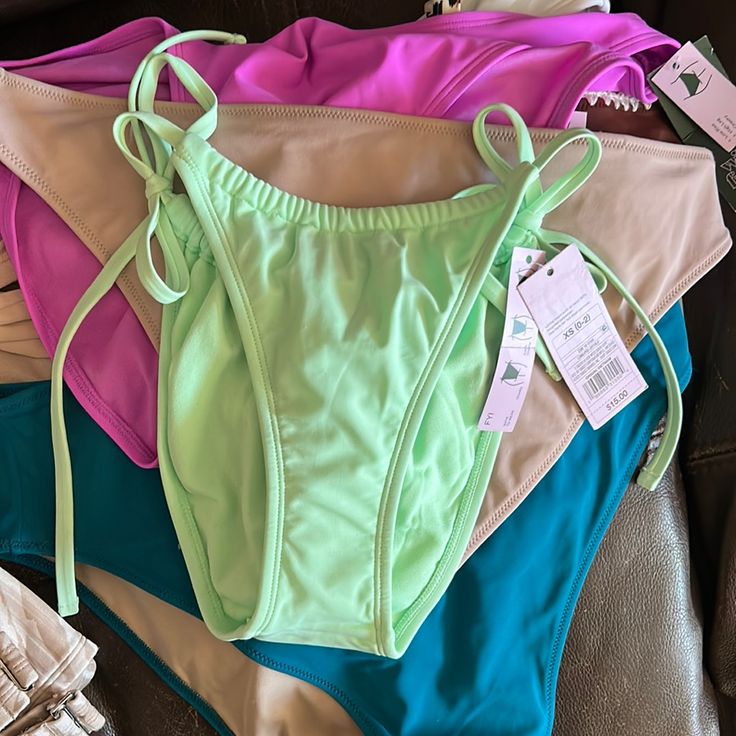 Brand New With Tags Wild Fable Light Green Side Tie High Waisted Bikini Bottoms Low-Rise Bikini Bottom In Light Green Side String Ties Adjustable Coverage Cheeky, High-Leg Silhouette Soft Fabric With Added Spandex Full Lining Cheeky Bikini Bottom From Wild Fable In Light Green. Made Of A Soft Fabric With Added Spandex And Full Lining For Comfortable Wear In And Out Of The Water. Tailored In A Low-Rise, High-Leg Silhouette. Side String Ties Complete The Look With A Customizable Fit And Coverage. Green Tie-side Bottom Swimwear, Bra Friendly, Green Bra-friendly Tie-side Swimwear, Summer Brief Bottoms With Built-in Bra, Summer Swimwear Briefs, Bra Friendly, Summer Swimwear Briefs Bra Friendly, Summer Swimwear Briefs Bra-friendly, Summer Bra-friendly Brief Swimwear, Summer Nylon Tankini With Briefs, Spring Green Swimwear With Drawstring