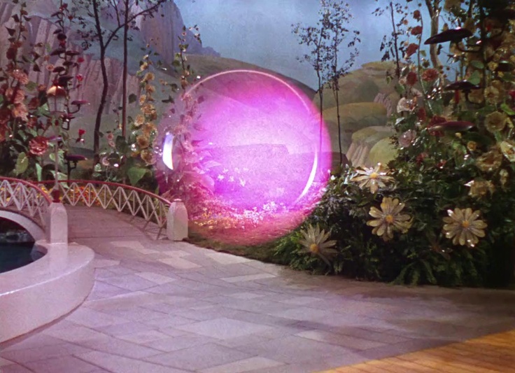 a large purple object sitting in the middle of a garden