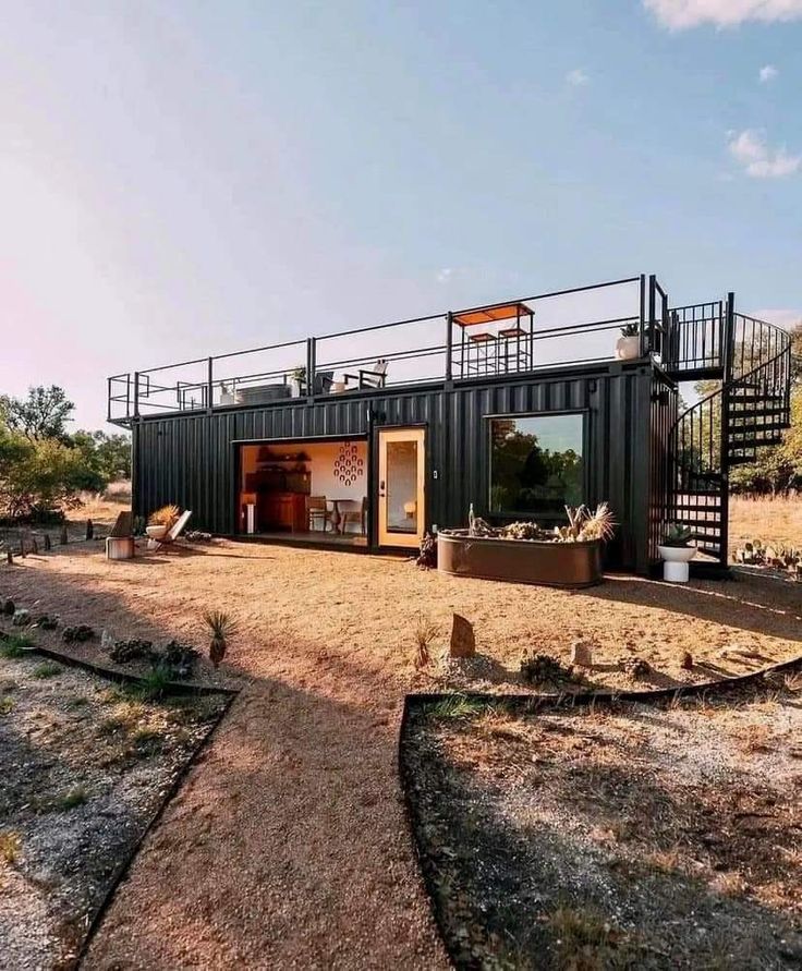 a house made out of shipping containers in the desert