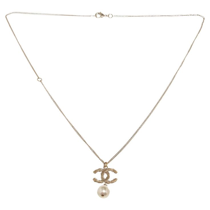 Gold-tone long chain Chanel CC necklace features dangle gold-tone CC logo and pearl pendant and lobster claw closure.   54116MSC Chanel Cc Necklace, Cc Necklace, Chanel Jewelry Necklace, Gold Tone Necklace, Cc Logo, Long Chain, Pearl Pendant, Lobster Claw, Gold Pendant