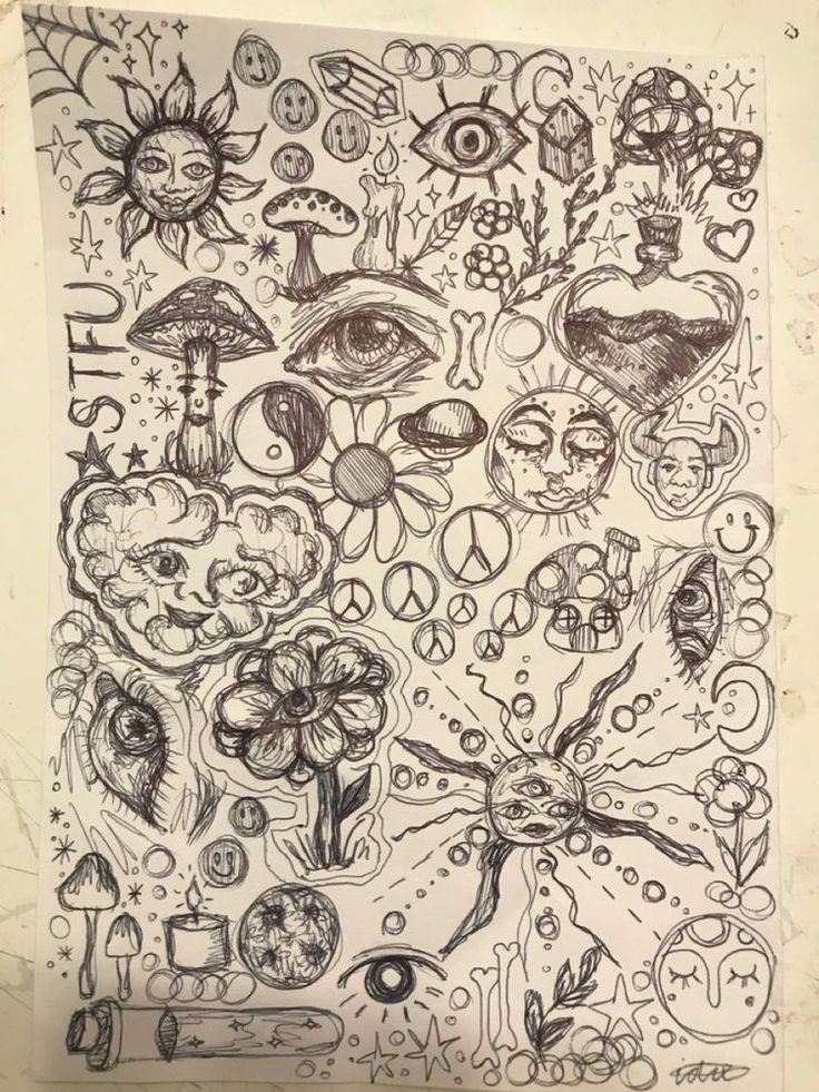 a drawing on paper with many different things in the background, including an eye and flowers