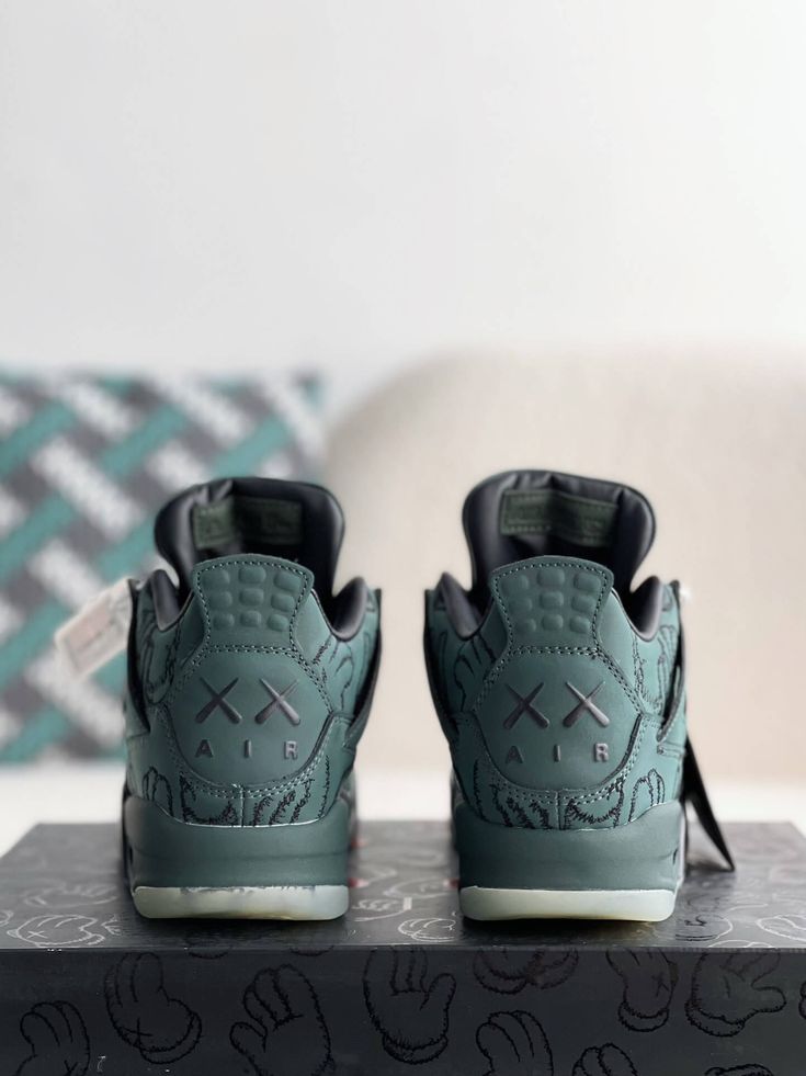 Embrace iconic artistry with the Air Jordan 4 Retro Kaws-inspired custom green sneakers. These statement shoes seamlessly blend the legendary Air Jordan silhouette with the distinctive flair of renowned artist KAWS. The monochromatic green colorway, featuring KAWS' signature "XX" motif subtly embossed throughout the upper, creates a unique and collectible look. Crafted with premium materials and meticulous attention to detail, these sneakers offer style and comfort. Step into the world of art an Green Custom Sneakers With Boost Midsole For Streetwear, Green Sneakers With Abzorb Midsole For Streetwear, Green High-top Custom Sneakers For Streetwear, Green Low-top Urban Custom Sneakers, Urban Green Low-top Custom Sneakers, Green Custom Sneakers With Translucent Outsole For Sports, Modern Green High-top Sneakers With Rubber Sole, Urban Green High-top Custom Sneakers, Urban Green High-top Sneakers With Boost Midsole