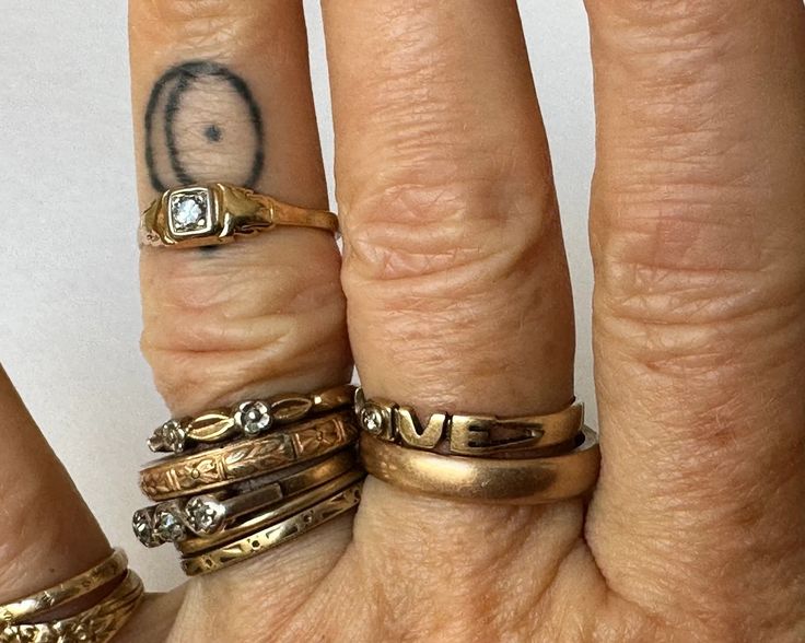 three different rings are stacked on top of each other with the word love written in them