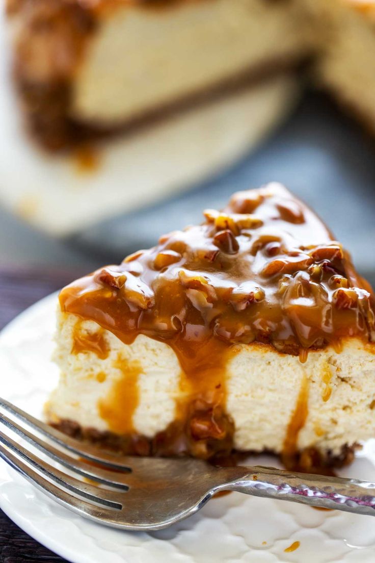 a piece of maple cheesecake on a white plate with a fork and caramel drizzle