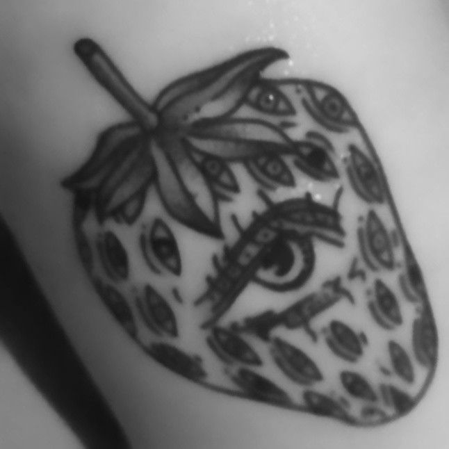 a black and white photo of a strawberry tattoo