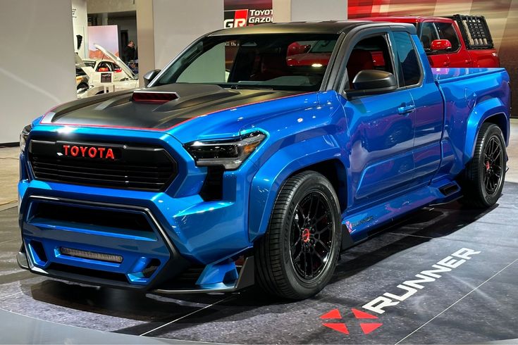 a blue toyota truck is on display at an auto show