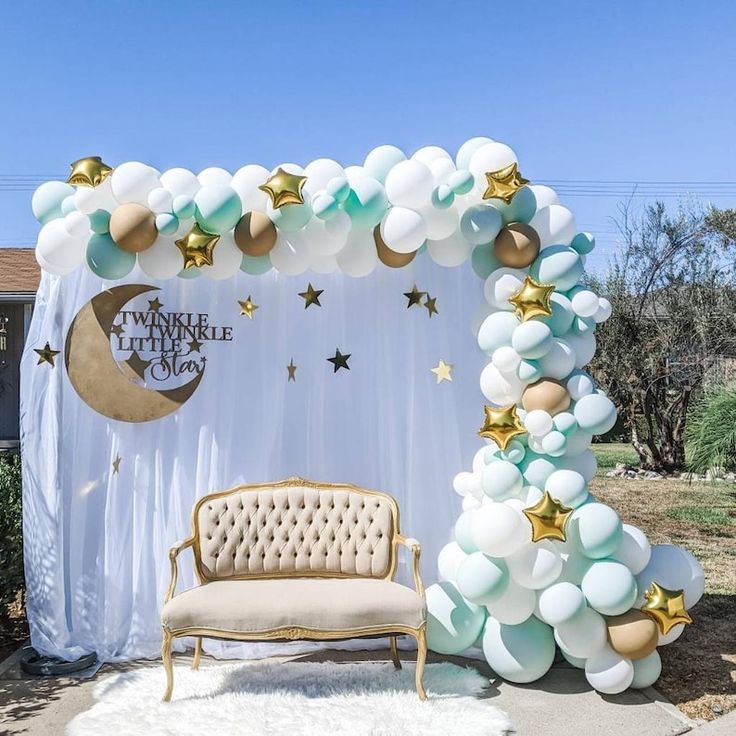 a couch sitting in front of a balloon arch