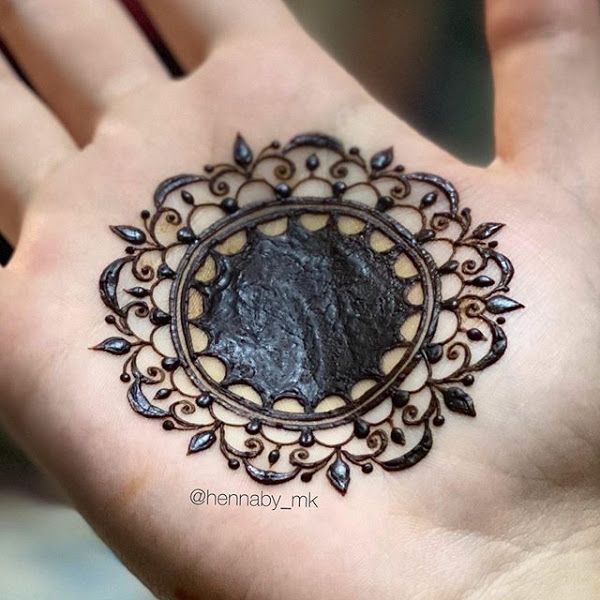 a person's hand with an intricate design on it