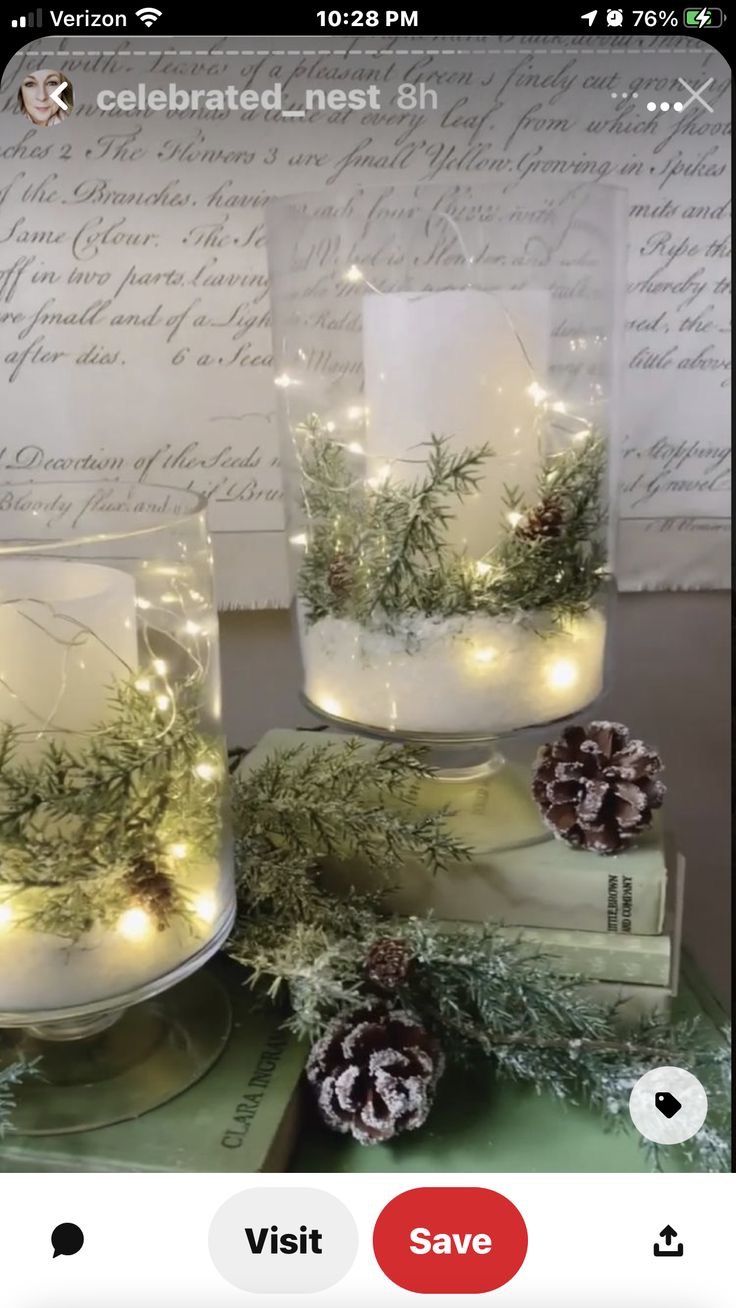 two glass vases filled with pine cones and greenery